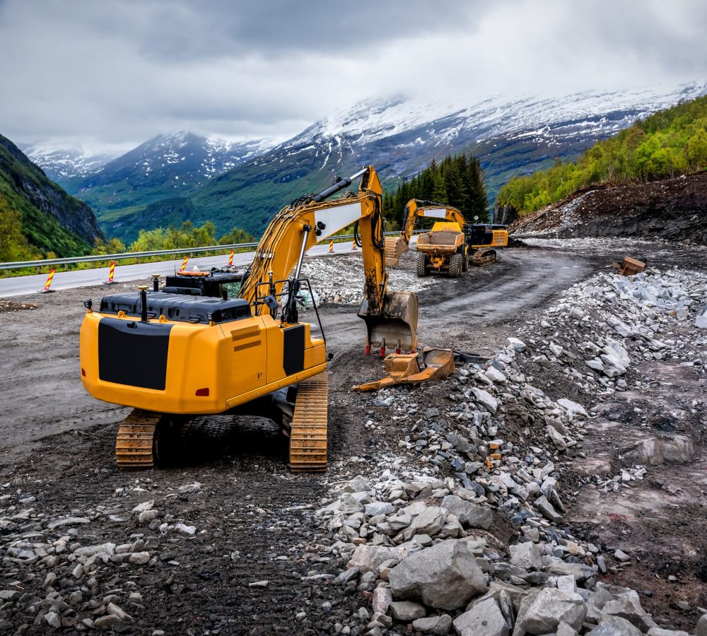 Industrial truck loader excavator moving earth and unloading into a dumper truck on the construction site. Industrial theme