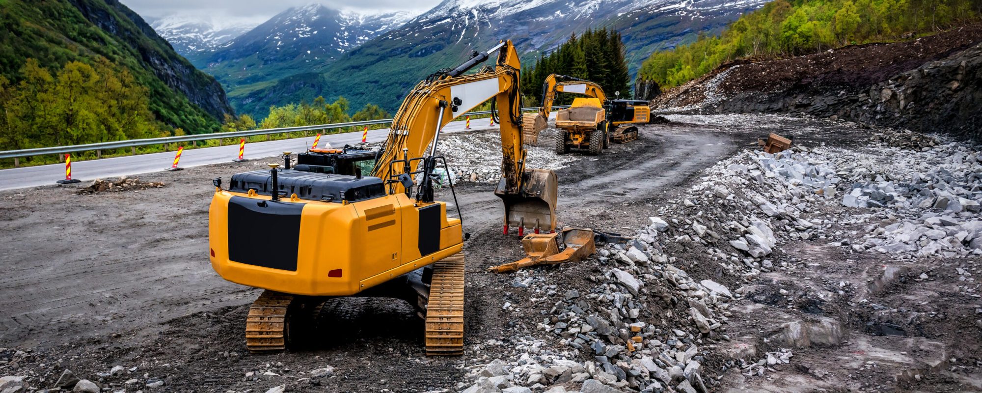 Industrial truck loader excavator moving earth and unloading into a dumper truck on the construction site. Industrial theme